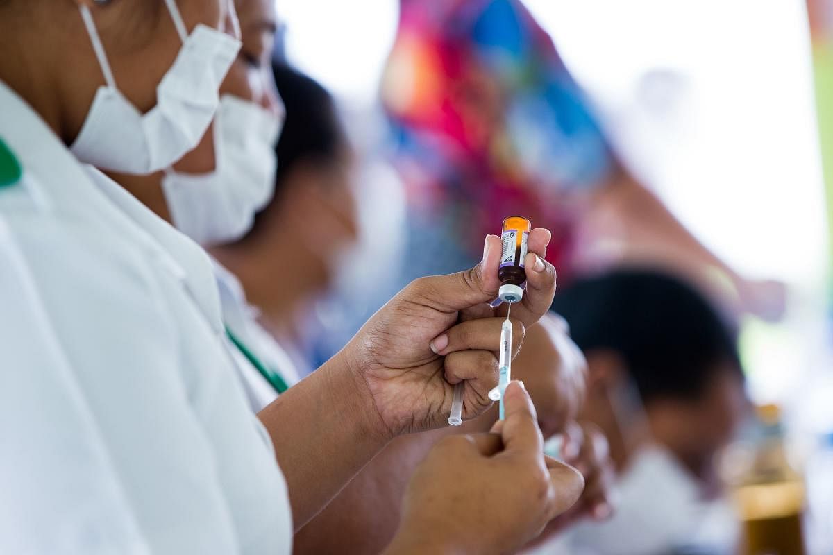 This handout picture taken on December 2, 2019 and released from UNICEF Samoa on December 4 shows nurse April Wilson (L) and team leader Luisa Popo preparing vaccinations during a nationwide campaign against measles in the Samoa. (AFP Photo)