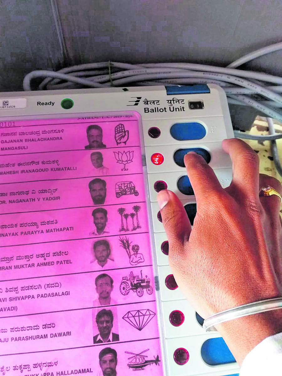 A voter's selfie with EVM taken in Athani Assembly constituency doing rounds on social media.