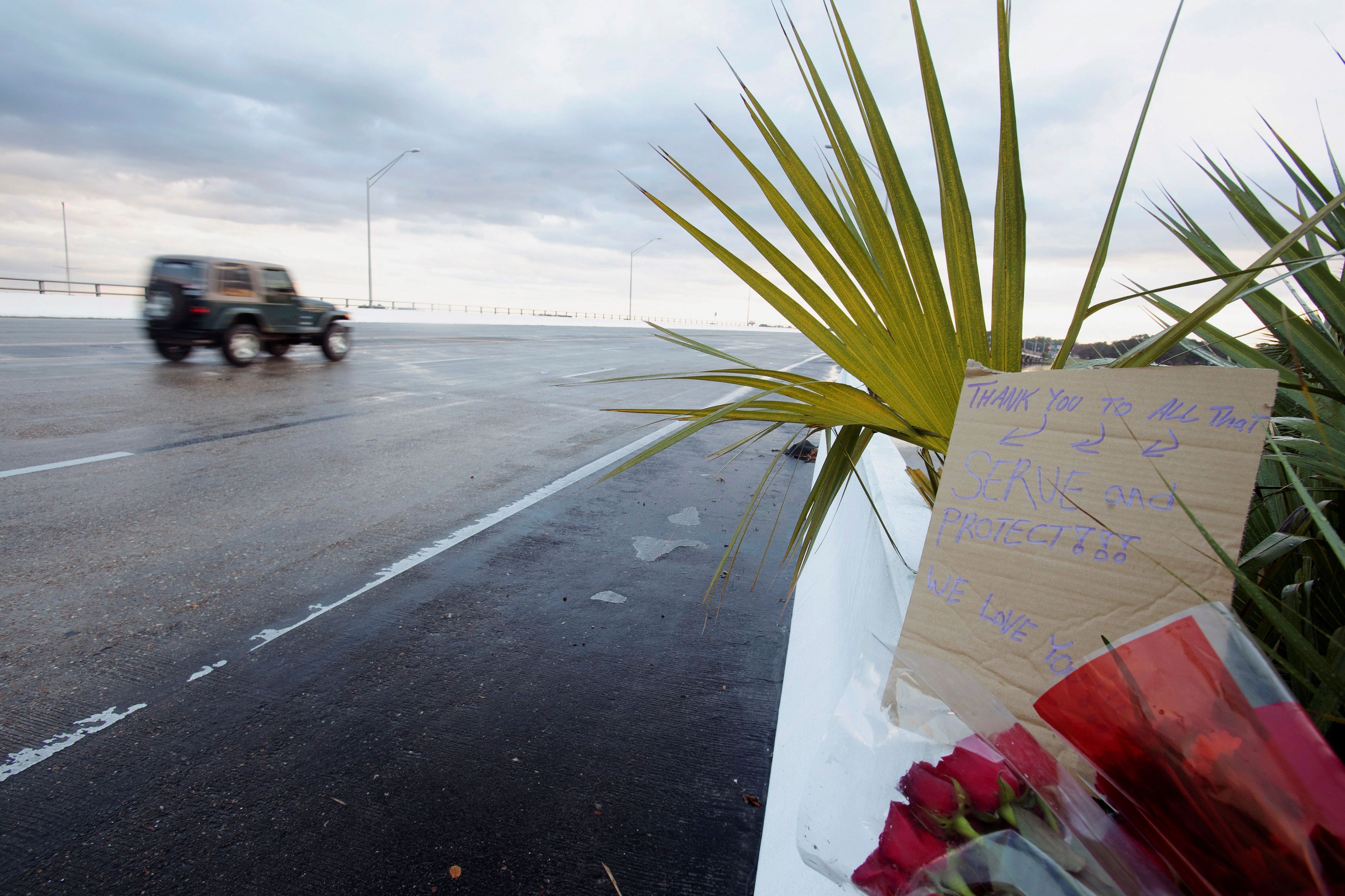 Flowers and a message are left on the entrance bridge after a member of the Saudi Air Force visiting the United States for military training was the suspect in a shooting at Naval Air Station Pensacola, in Pensacola. (Reuters Photo)