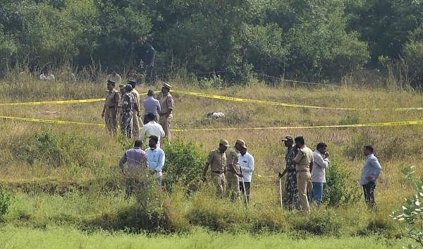 Policemen stand guard the area where four accused in the rape-and-murder case of a 25-year-old woman veterinarian were shot dead by police, at Shadnagar of Ranga Reddy district in Hyderabad, Friday, Dec. 6, 2019. (PTI Photo/Shailendra Bhojak)