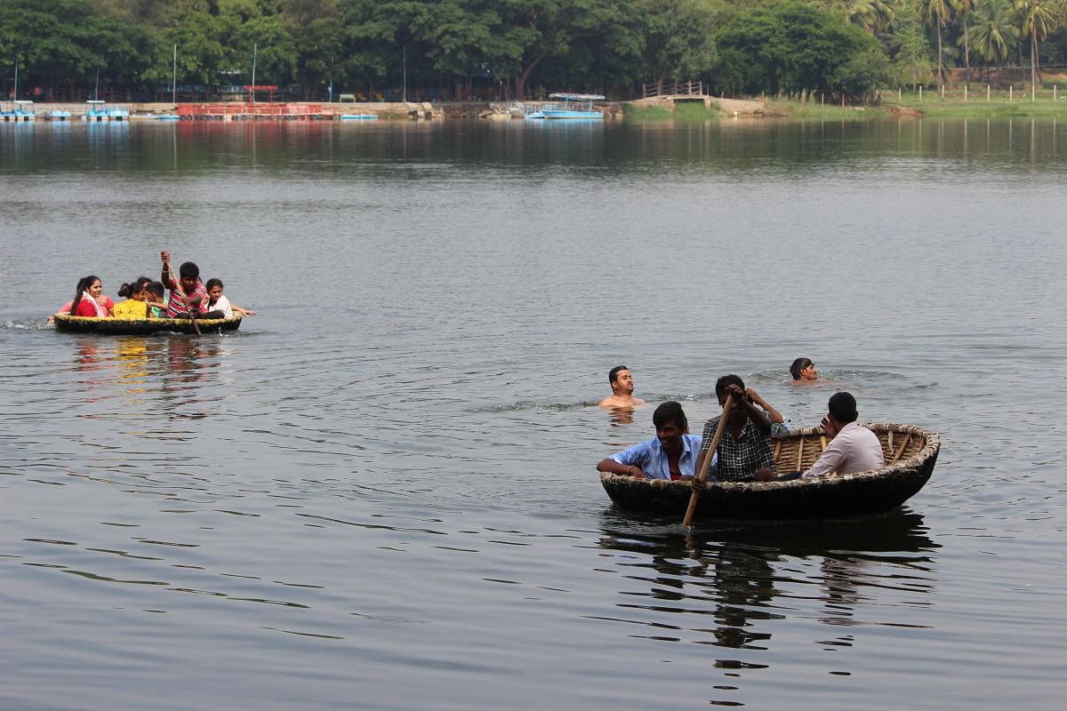 (Clockwise) Tourists enjoy the coracle ride in Jaladhama, Talakadu