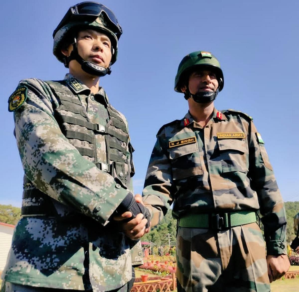 Officers of Indian army and PLA of China shake hands during the inauguration of the joint military exercise at Umroi military station in Meghalaya on Saturday. DH Photo