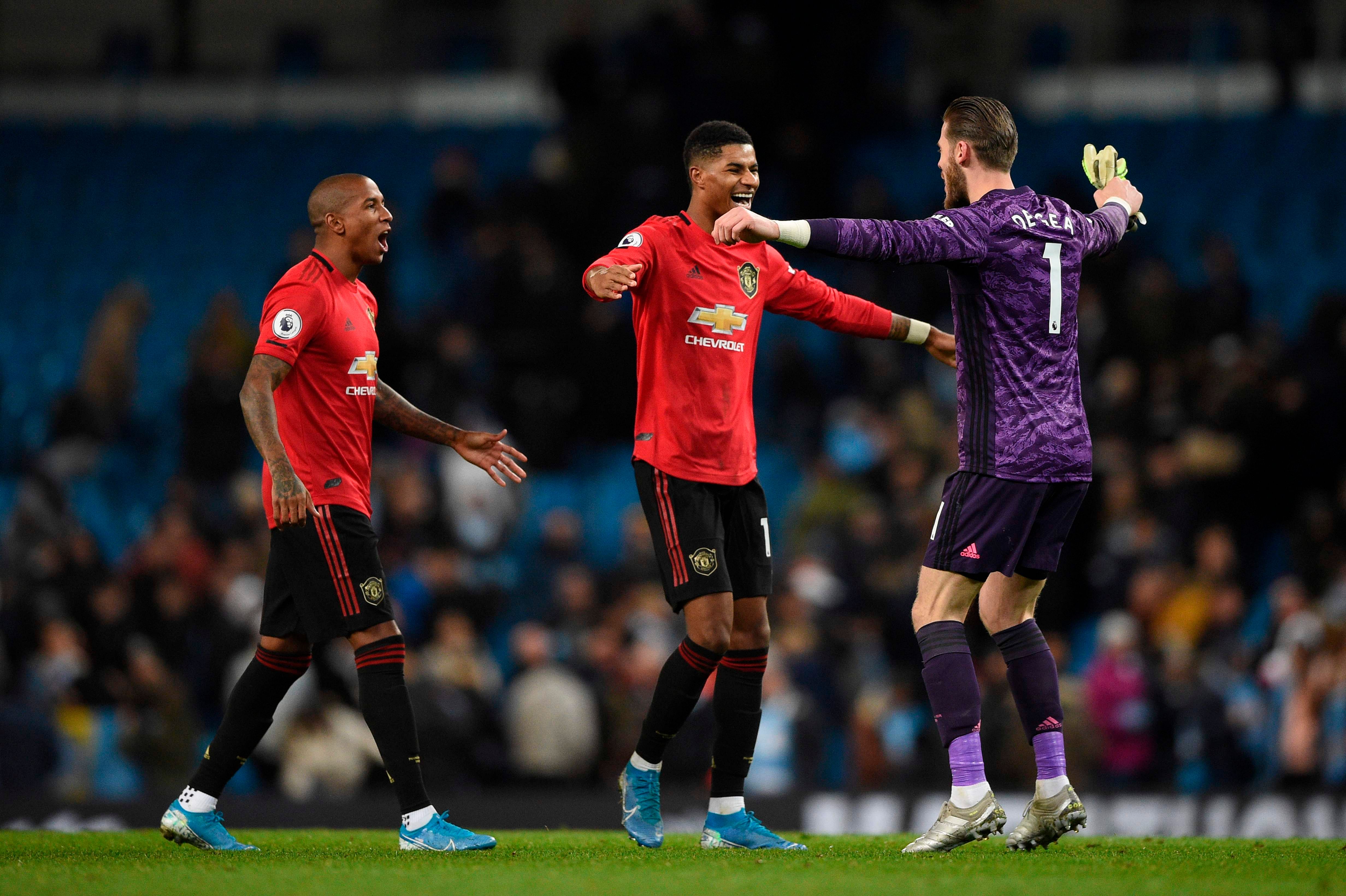 Manchester United's English defender Ashley Young, Manchester United's Spanish goalkeeper David de Gea and Manchester United's English striker Marcus Rashford celebrate victory at the end of the English Premier League football match between Manchester City and Manchester United at the Etihad Stadium in Manchester, north west England. (AFP Photo)