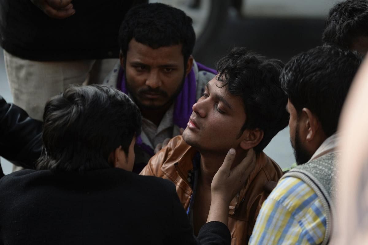 A fire victim relative reacts outside the mortuary of a hospital in New Delhi (AFP Photo)