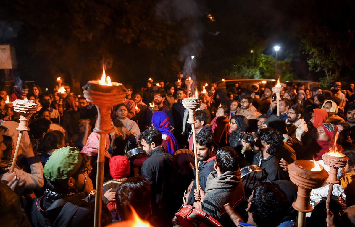 JNU students take part in a Mashal Juloos (torch light procession) to protest against the proposed fee hike and IHA mannual. (PTI Photo)