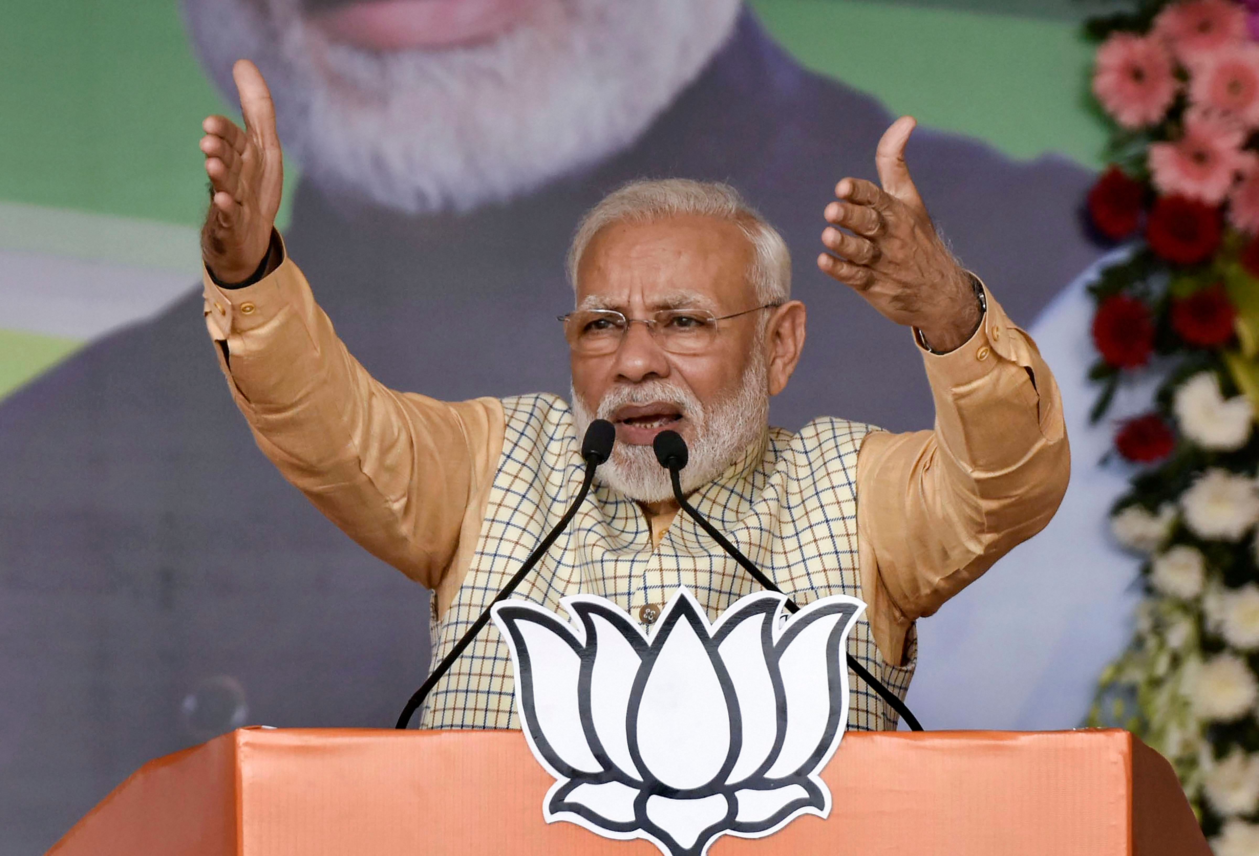 Prime Minister Narendra Modi gestures as he speaks during an election campaign rally, ahead of 2nd phase of State Assembly elections, at Khunti district of Jharkhand. (PTI Photo)