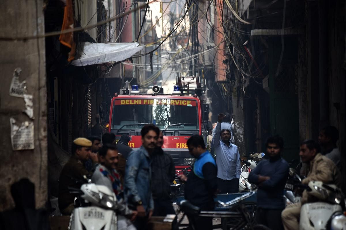 A Delhi Fire Service truck is seen along a street near the site of a facotry where a fire broke out, in Anaj Mandi area of New Delhi. AFP