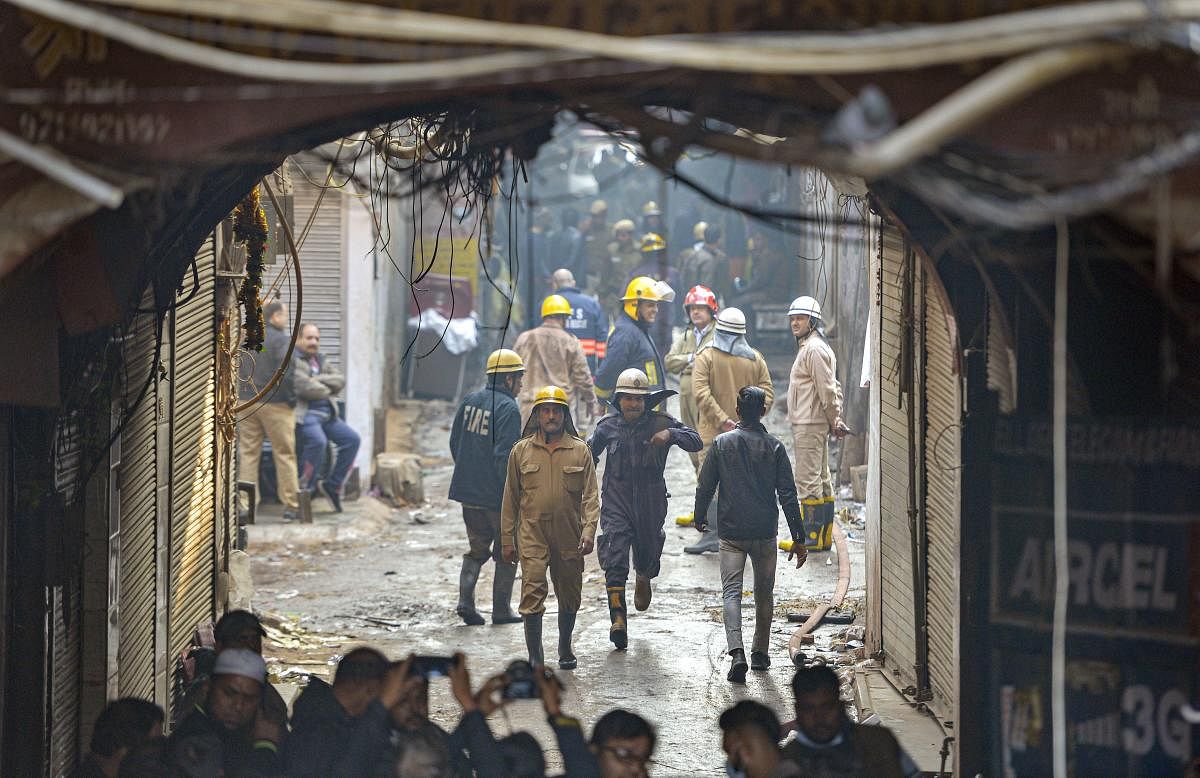 Police and fire personnel carry out rescue operations near a factory at Rani Jhansi Road where a major fire broke out, in New Delhi, Sunday, Dec. 8, 2019. At least 43 people were killed and several others injured in the mishap. (PTI Photo)