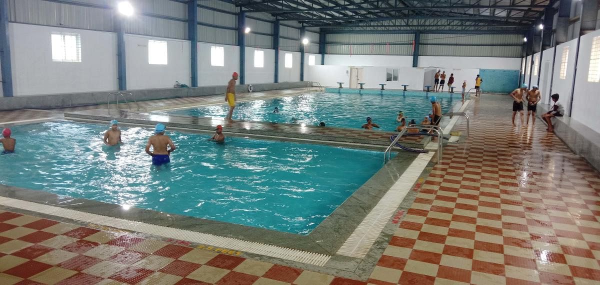 Children enjoy swimming at the pool in General K S Thimayya District Stadium in Madikeri.