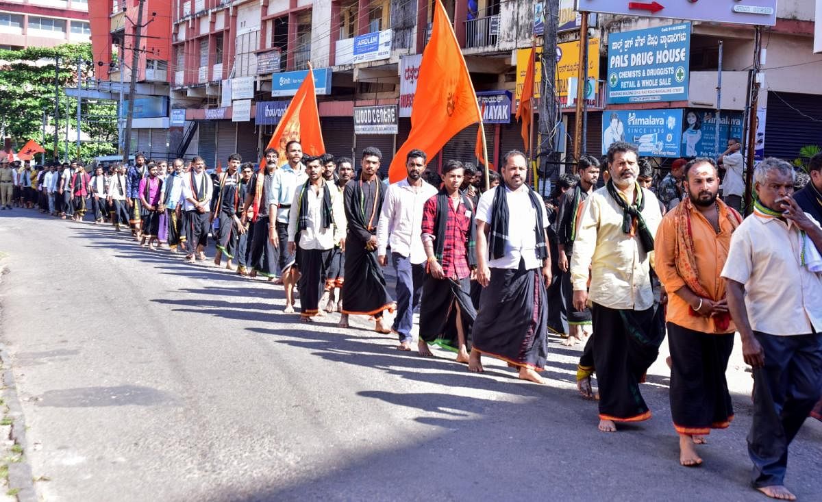 Ayyappa devotees take out a procession from Sharavu Temple to Town Hall in Mangaluru on Sunday. DH photo