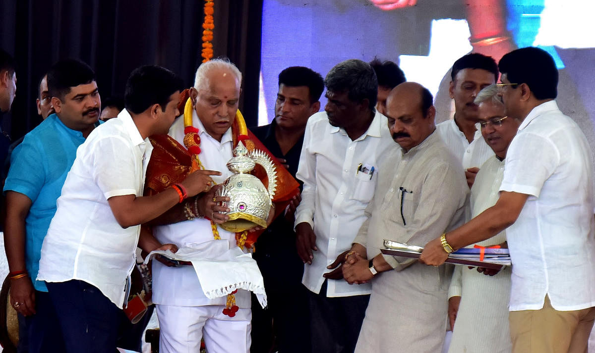 Chief Minister B S Yediyurappa was presented with a silver crown during the groundbreaking of various development works in Belthangady constituency, at a formal function held in Ratnavarma stadium in Ujire on Sunday. Home and Cooperation Minister Basavara