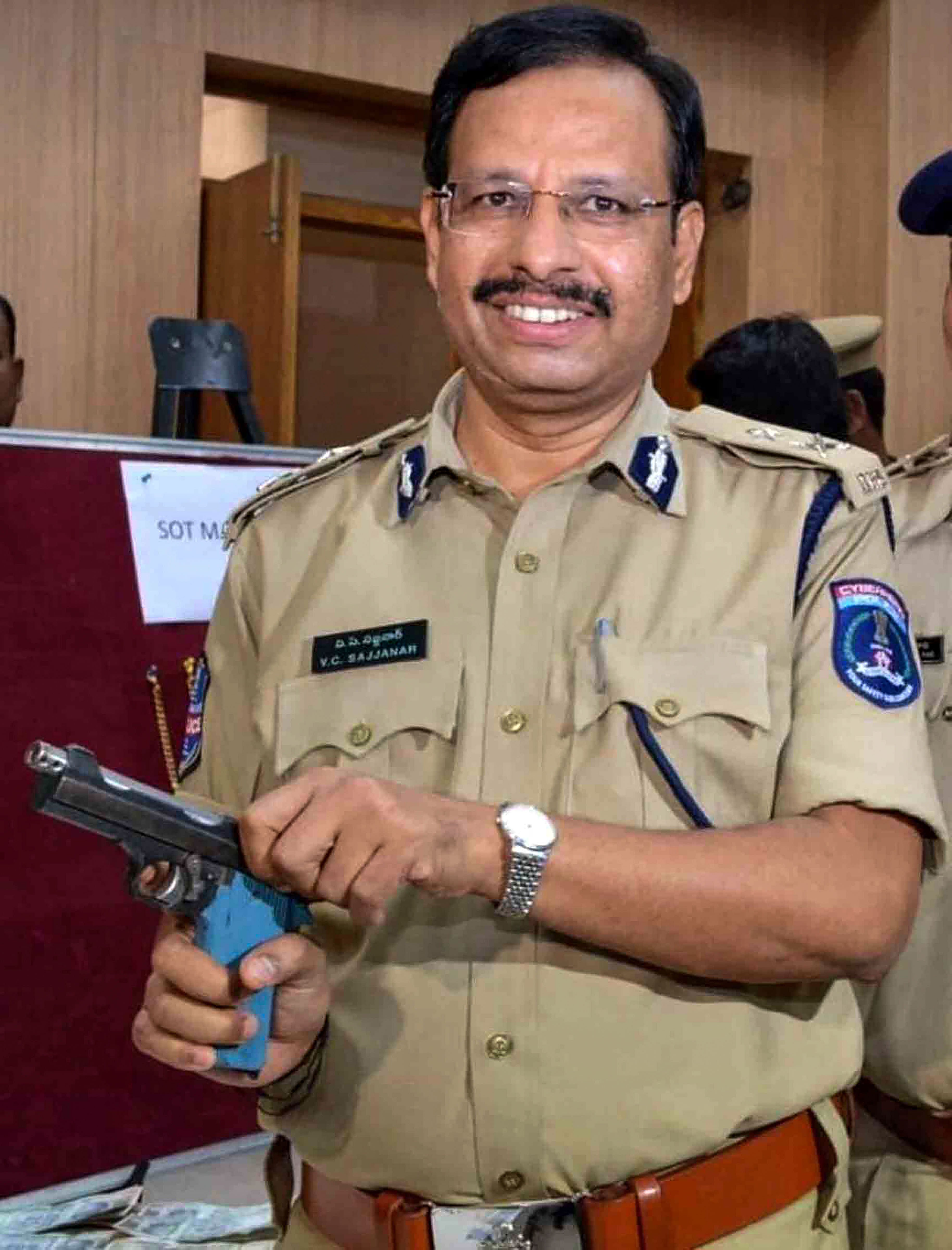 Cyberabad Police Commissioner V C Sajjanar pose with a gun. (PTI Photo)