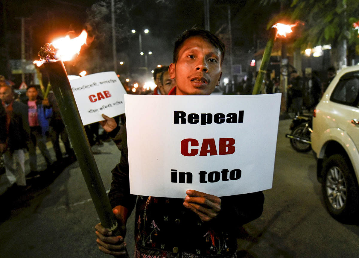 People holding torches march during a protest over the Citizenship Amendment Bill, 2019 (CAB) in Guwahati,(PTI Photo)