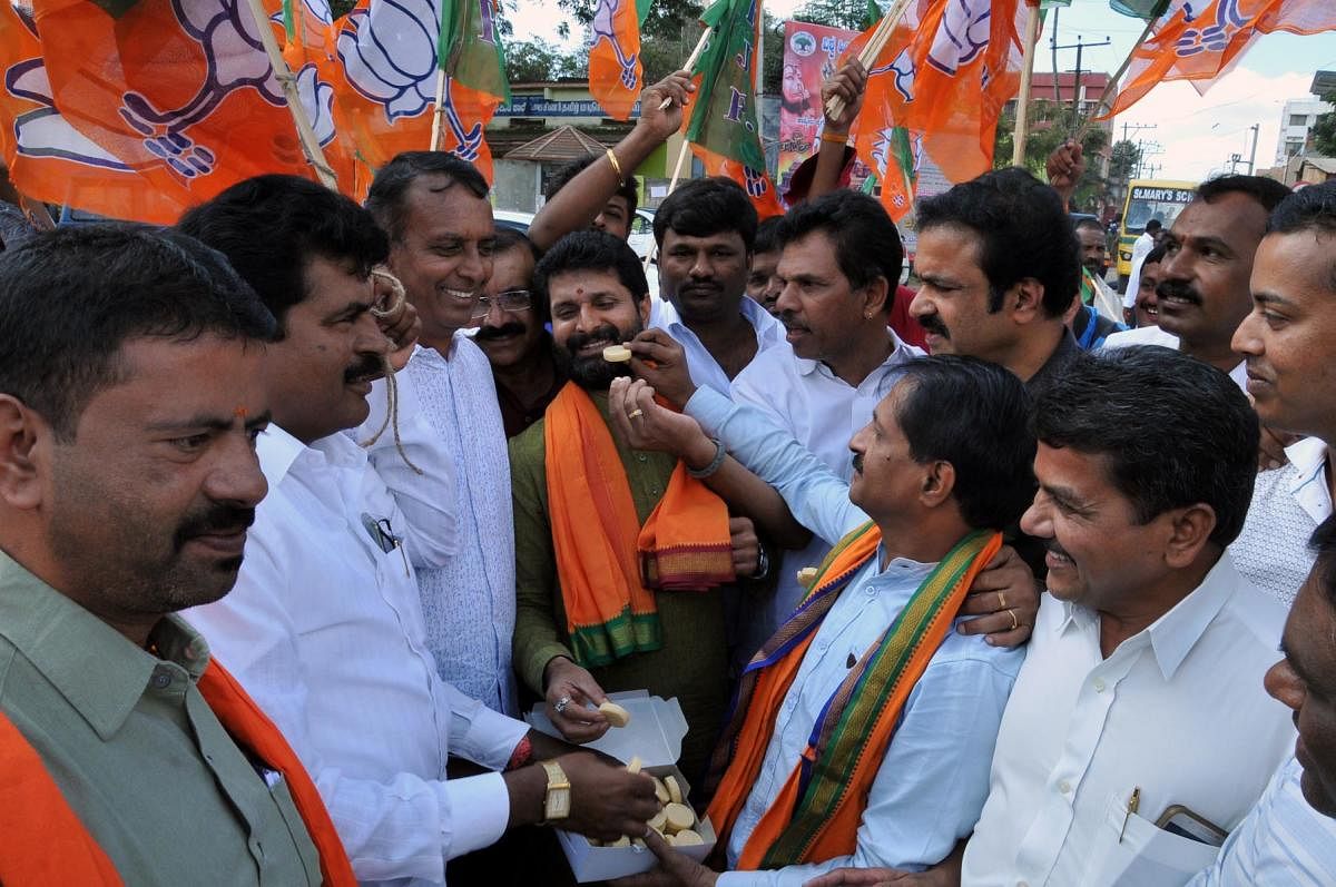 BJP workers offer sweets to Minister C T Ravi at Chikkamagaluru.