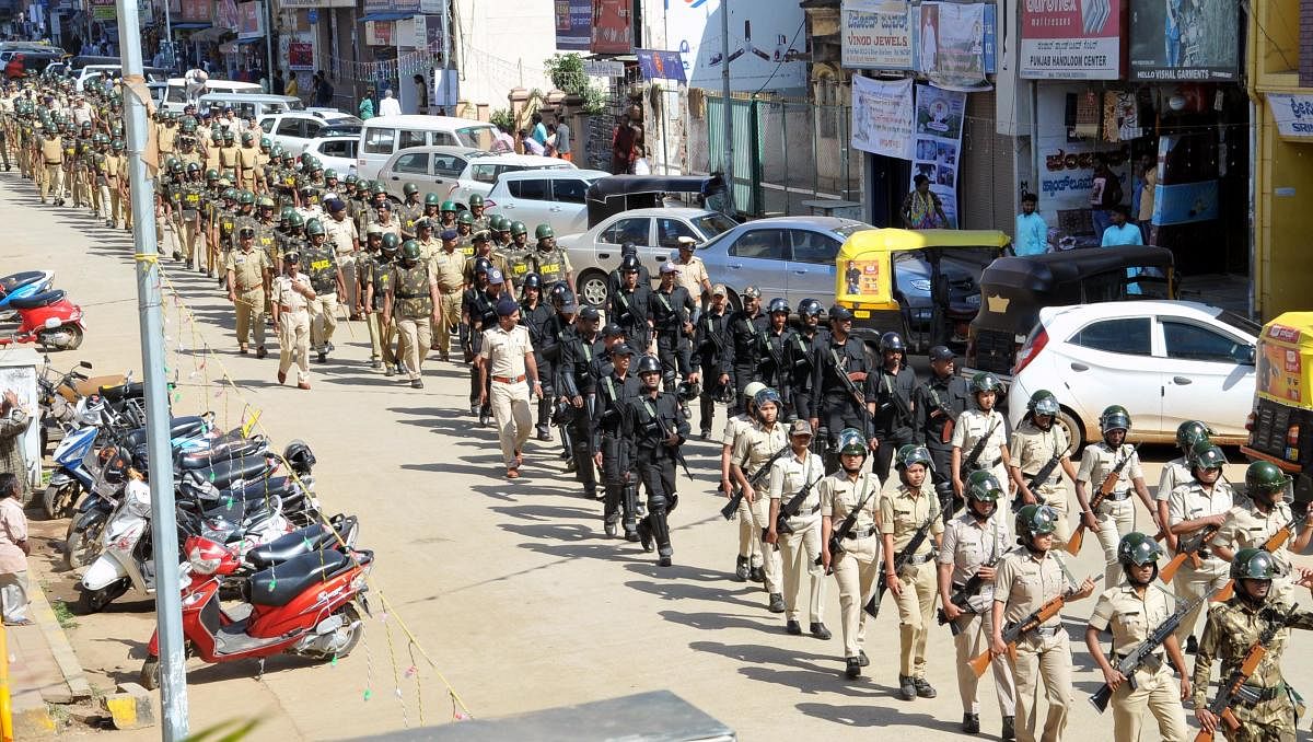 The police personnel carry out route march in Chikkamagaluru on Monday.