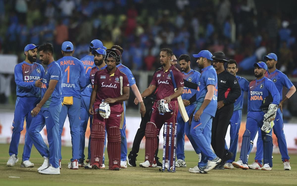 West Indies players Lendl Simmons and Nicholas Pooran being greeted by Indian players after win the second T20 cricket match at Greenfield International Cricket Stadium, in Thiruvananthapuram. (PTI file photo)