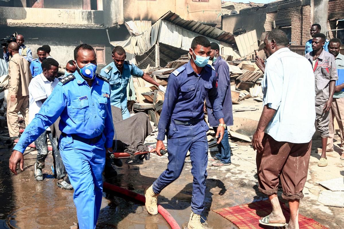Sudanese Civil Defence transport the bodies of victims of a fire at a tile manufacturing unit in an industrial zone in north Khartoum. (Photo by AFP)