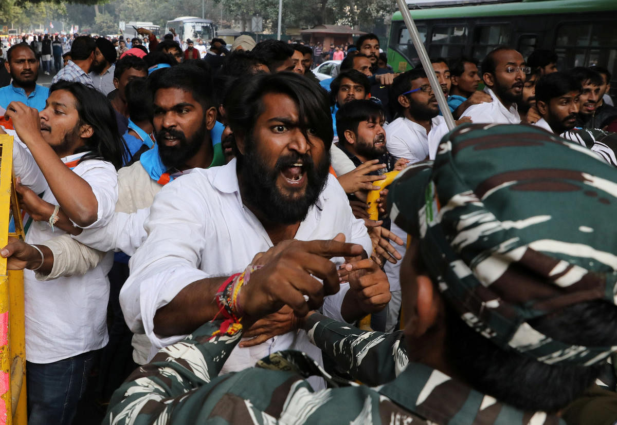 Demonstrators scuffle with police officers during a protest organised by NSUI against fee hikes and to demand better education in New Delhi. Reuters