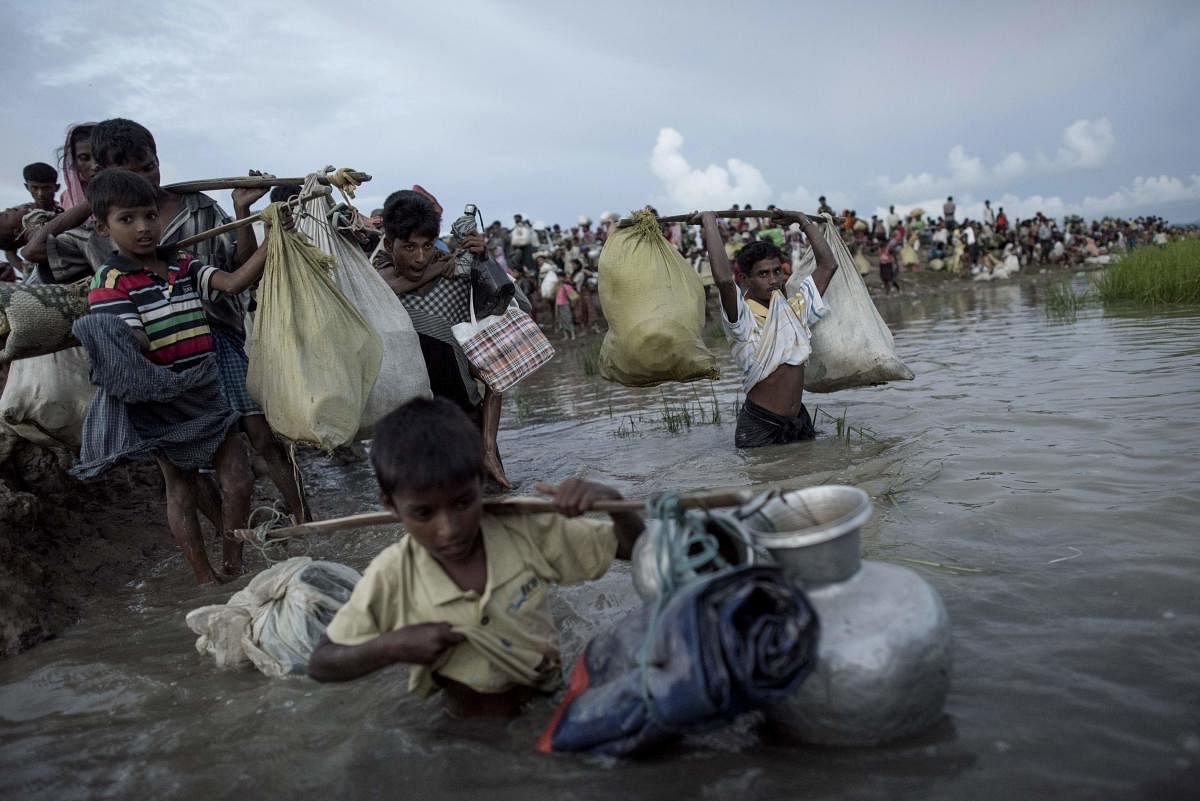  In this file photo taken on October 10, 2017, Rohingya refugees walk after crossing the Naf river from Myanmar into Bangladesh in Whaikhyang. (AFP photo)