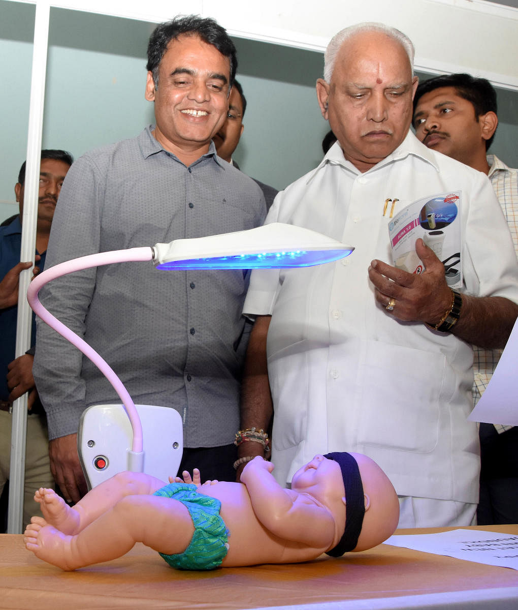 Deputy Chief Minister Dr Ashwath Narayan and Chief Minister B S Yediyurappa look at an exhibit at an event organised to mark 100 days of Ashwath Narayan taking charge as minister for higher education and medical education in Bengaluru on Wednesday. DH Pho