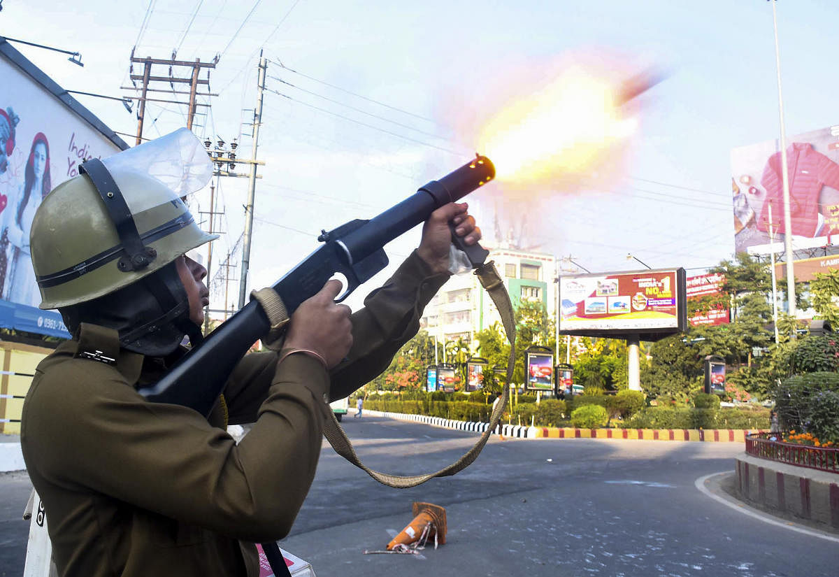  Police fire teargas shells to disperse protesters during their clashes as they march against the Citizenship (Amendment) Bill, 2019, in Guwahati.  (PTI Photo)