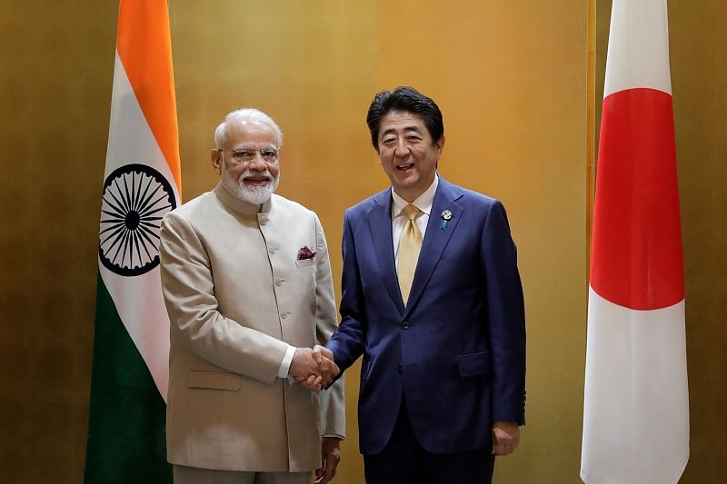 Narendra Modi, India's prime minister, shakes hands with Shinzo Abe, Japan's prime minister. (Reuters Photo)