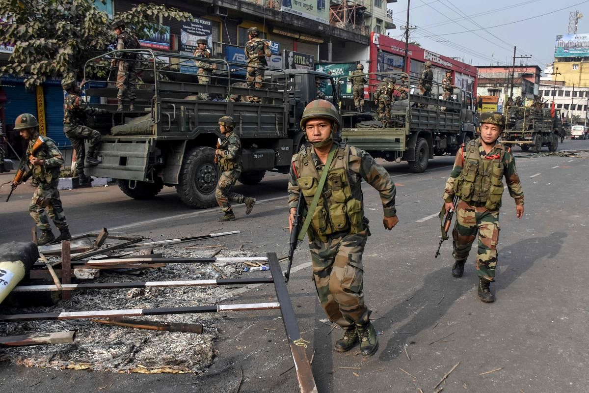 ndian soldiers look on as they patrol near the burnt wreckage of a vehicle during a curfew in Guwahati on December 12, 2019, following protests over the government's Citizenship Amendment Bill (CAB).(AFP Photo)