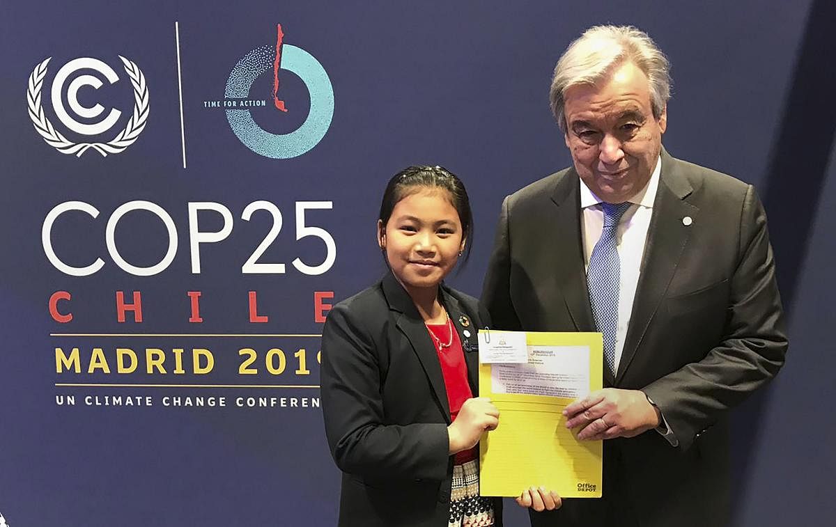 Activist Licypriya Kangujam (R) from Manipur poses for a photograph with UN chief Antonio Guterres at COP 25 in Madrid. (PTI Photo)