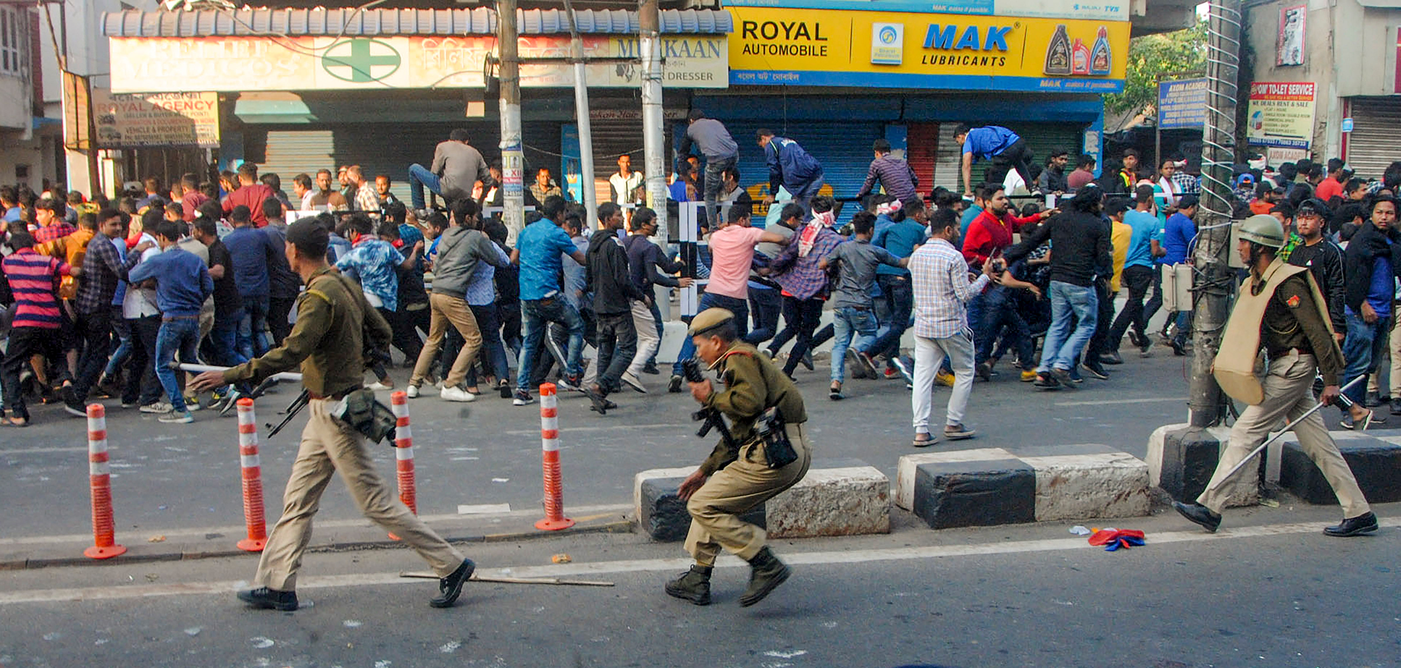 Guwahati: Police attempt to disperse protestors during anti-CAB demonstrations, in Guwahati. (PTI Photo)