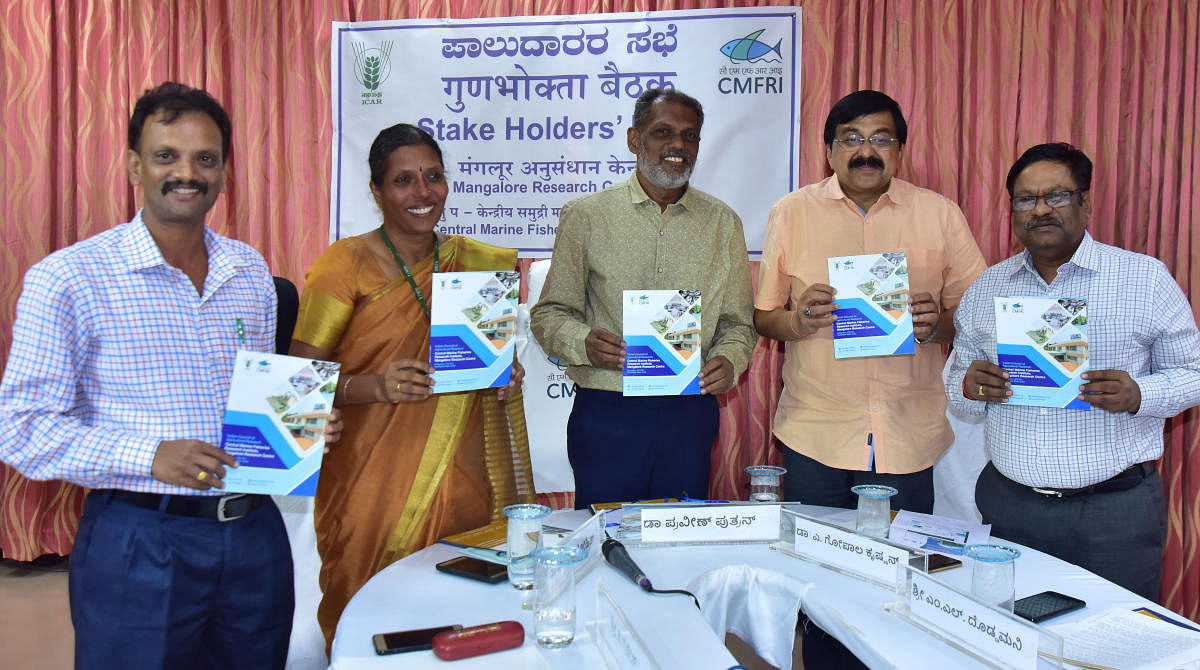 Dr Praveen Puthran, Assistant Director General (Marine Fisheries), ICAR, New Delhi, CMFRI, Kochi Director Dr Gopalakrishnan and others release a handbook on the activities of CMFRI, Mangaluru on Friday. DH Photo