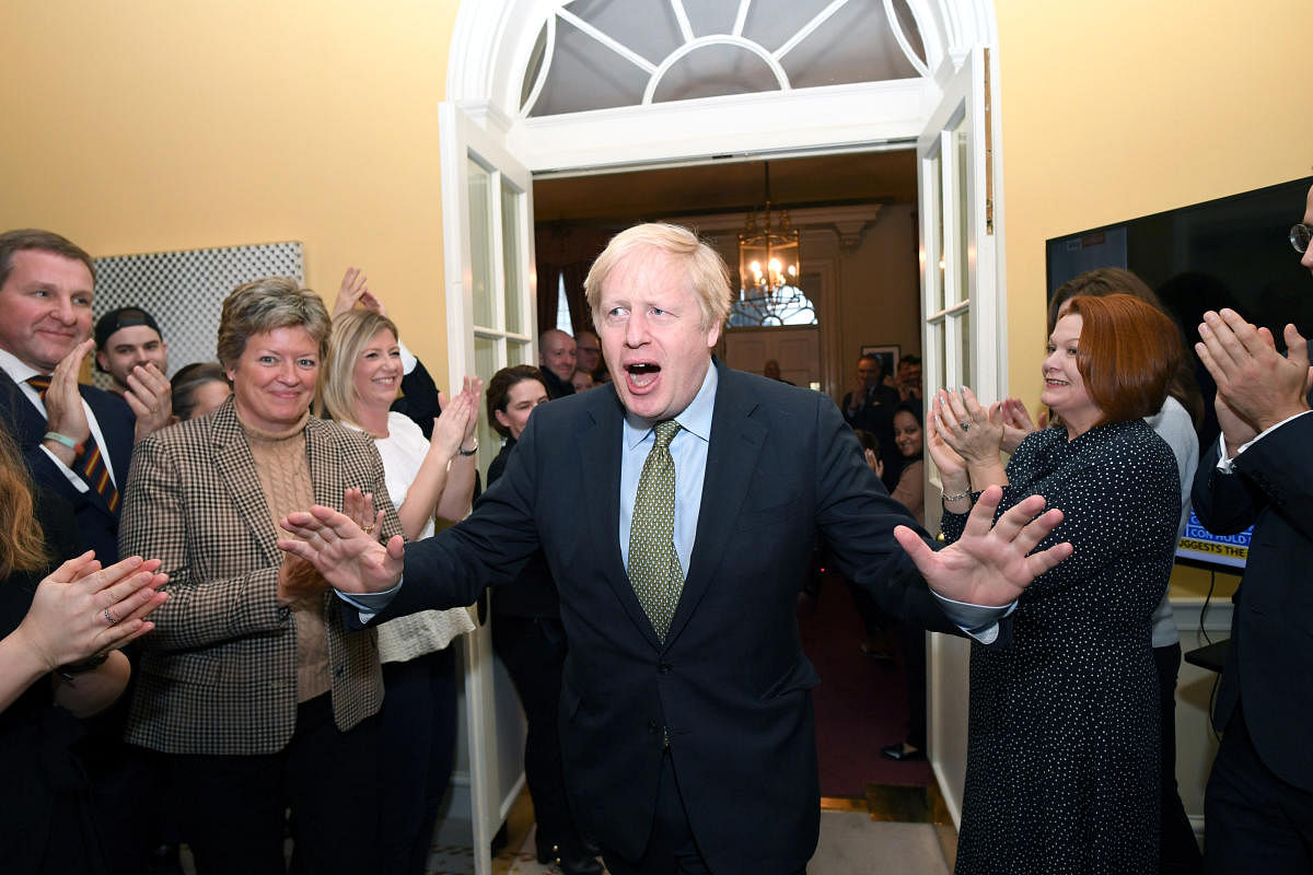 Britain's Prime Minister Boris Johnson is greeted by staff as he arrives back at Downing Street. (Reuters Photo)