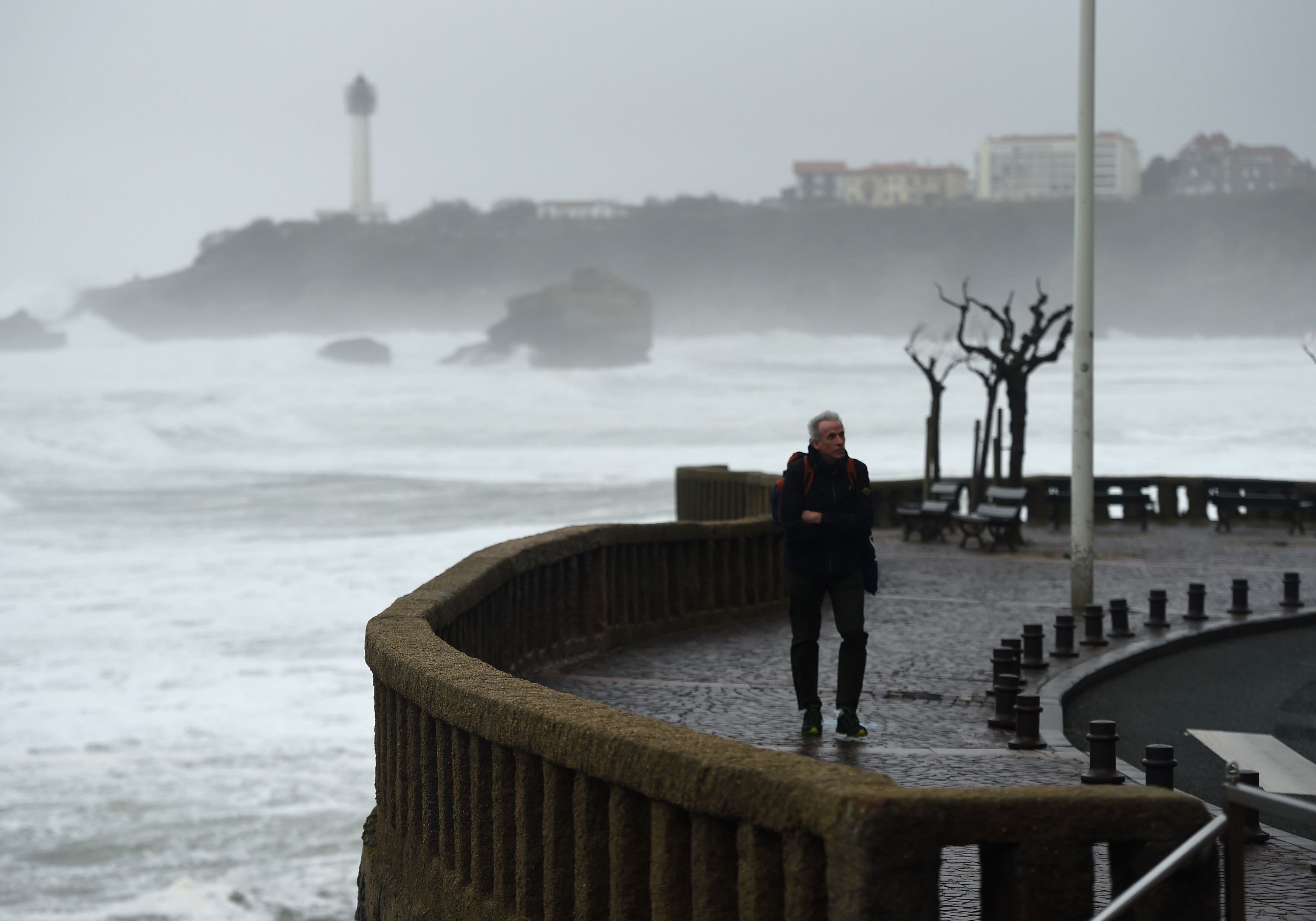 A man walks during the storm near the Grande Plage in Biarritz, southwestern France. (AFP Photo)