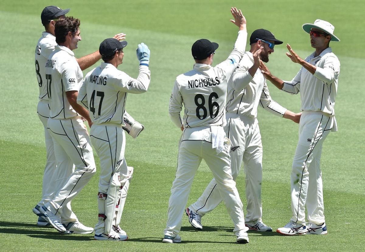 New Zealand's Jeet Raval (R) celebrates catching Australia's Matthew Wade on day four of the first Test cricket match between Australia and New Zealand at the Perth Stadium. (AFP Photo)