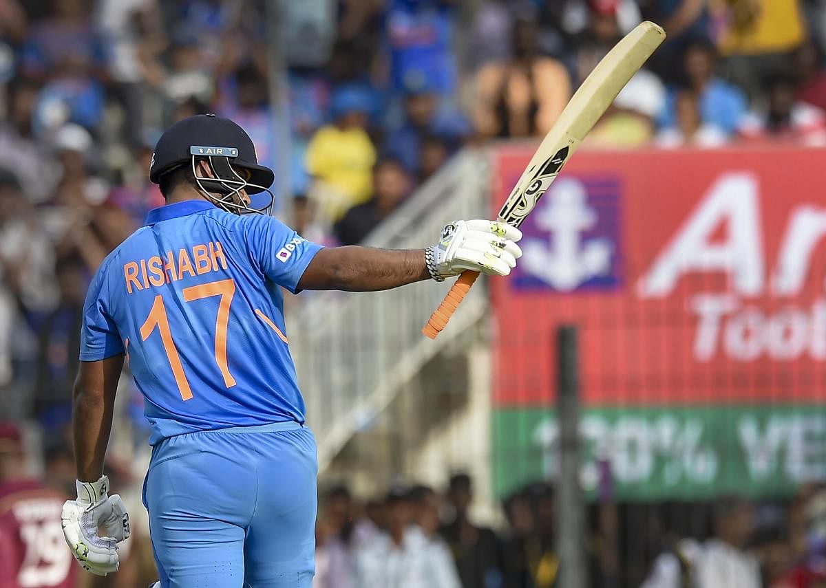 Indian batsman Rishabh Pant raises his bat after completing his half-century during the first One-Day International (ODI) cricket match against West Indies, at MAC Stadium in Chennai. PTI