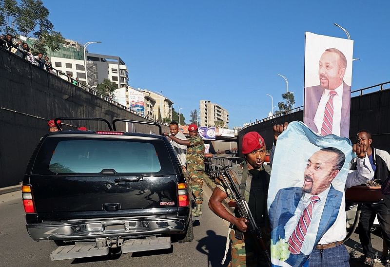 A republican guard pushes a man celebrating the return of Ethiopia's Prime Minister Abiy Ahmed from Oslo, where he received the Nobel Peace Prize, in Addis Ababa, Ethiopia. (Reuters Photo)