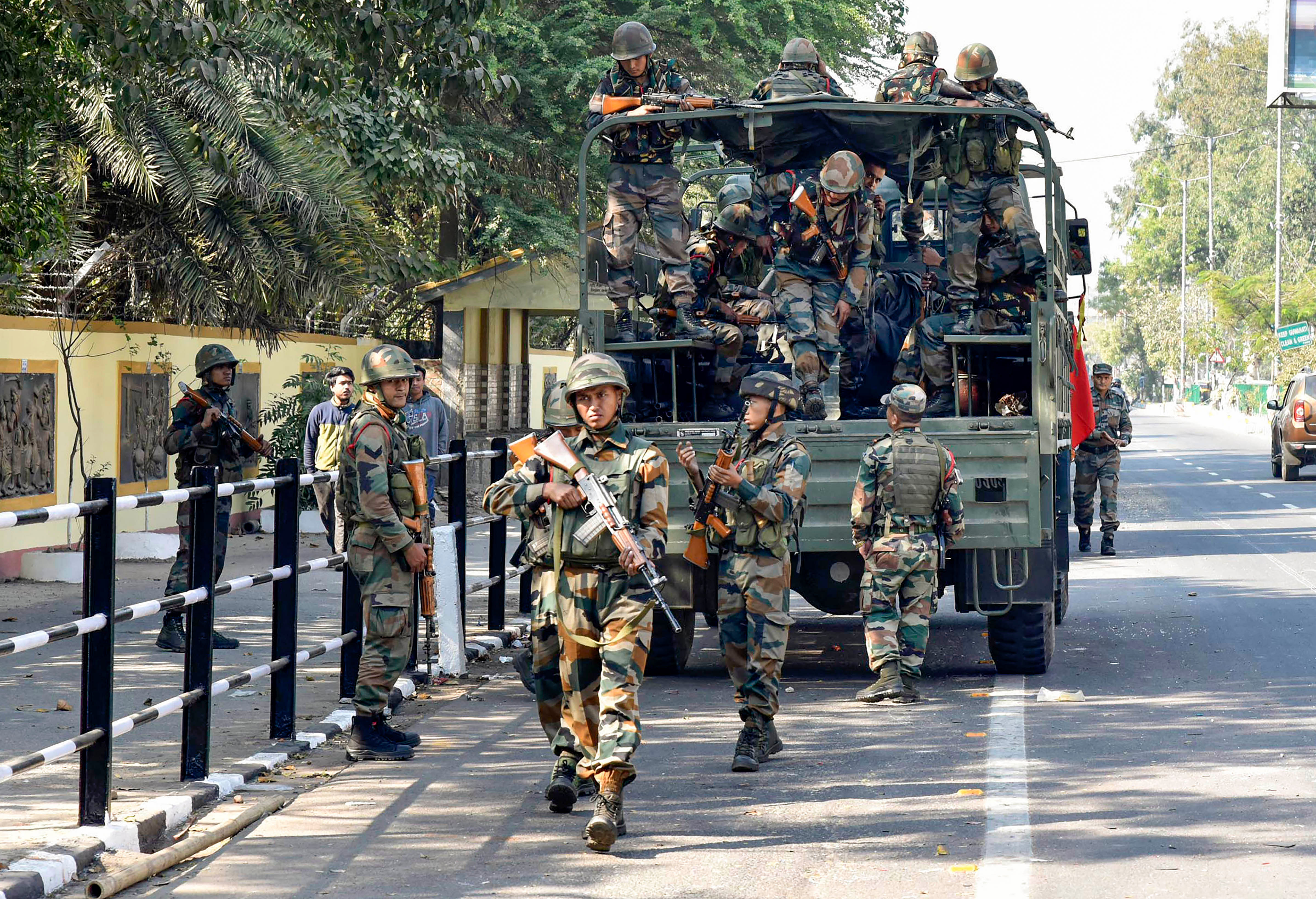 Army personnel get down from their vehicle to patrol the streets amid protests across the state against the passing of Citizenship Amendment Bill, in Guwahati. (PTI Photo)