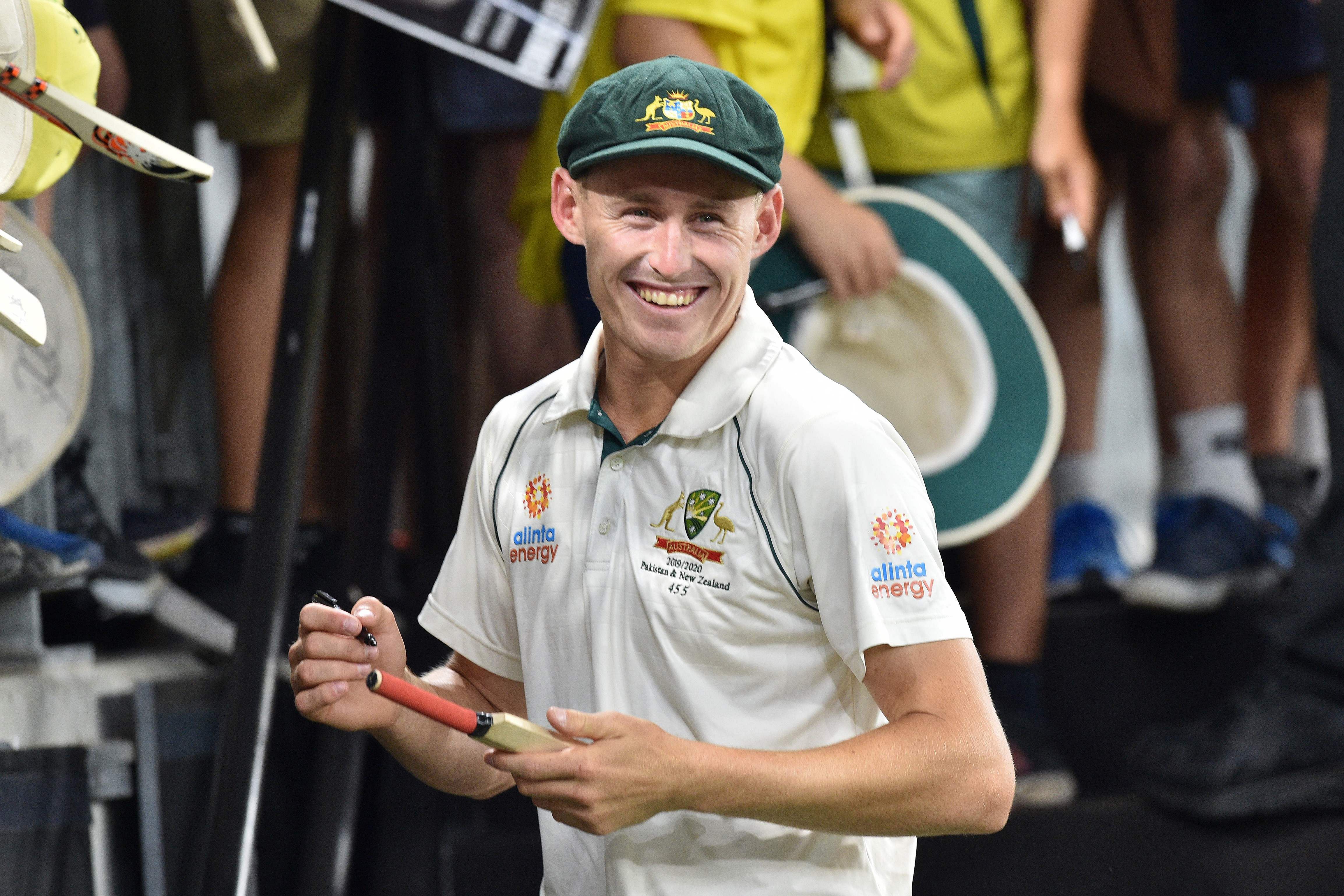 Australia's Marnus Labuschagne signs autographs after Australia beat New Zealand on day four of the first Test cricket match between Australia and New Zealand at the Perth Stadium in Perth. (AFP Photo)