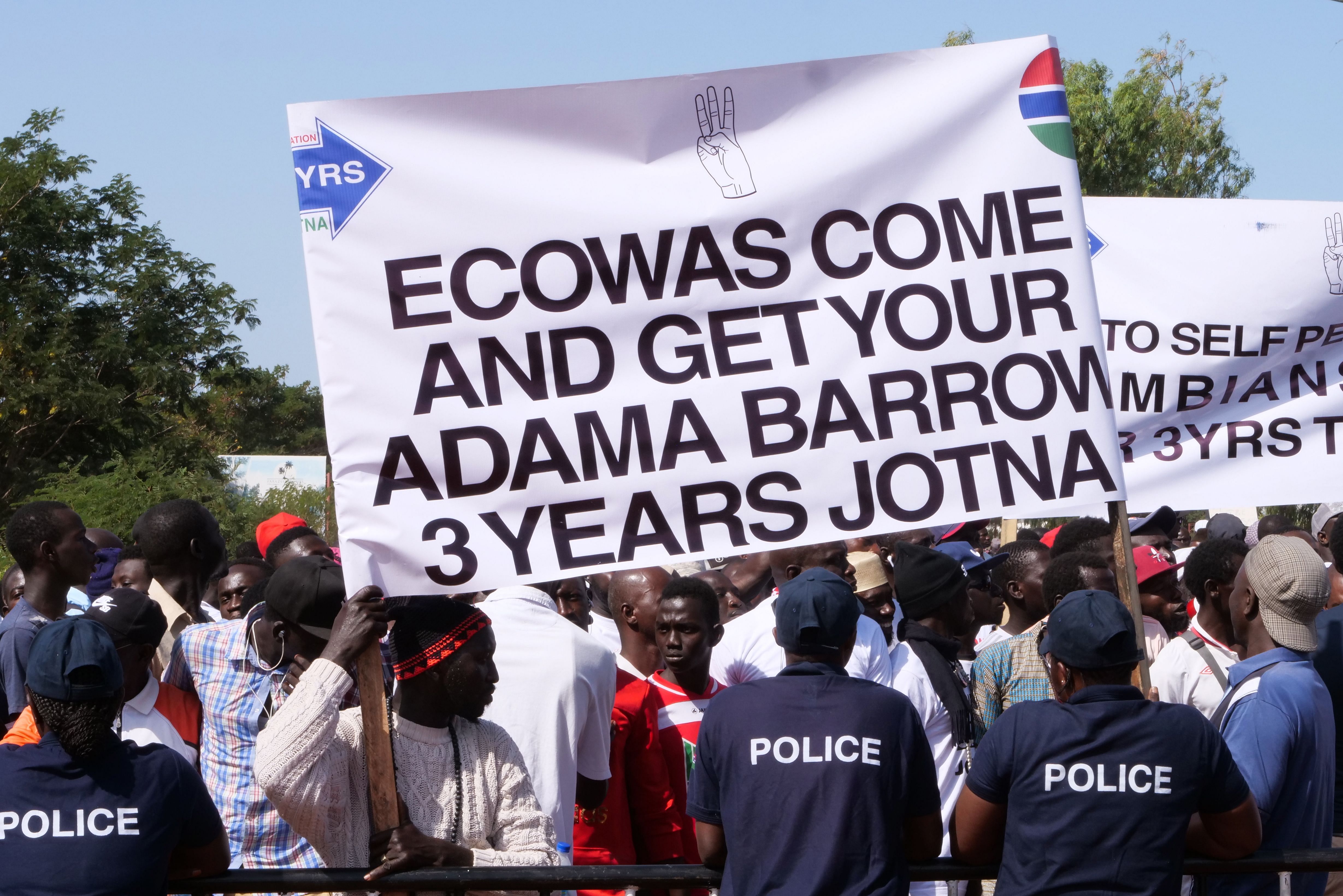 rotesters hold a banner as they take part in a demonstration against Gambian President, in Banjul, Gambia. (AFP Photo)