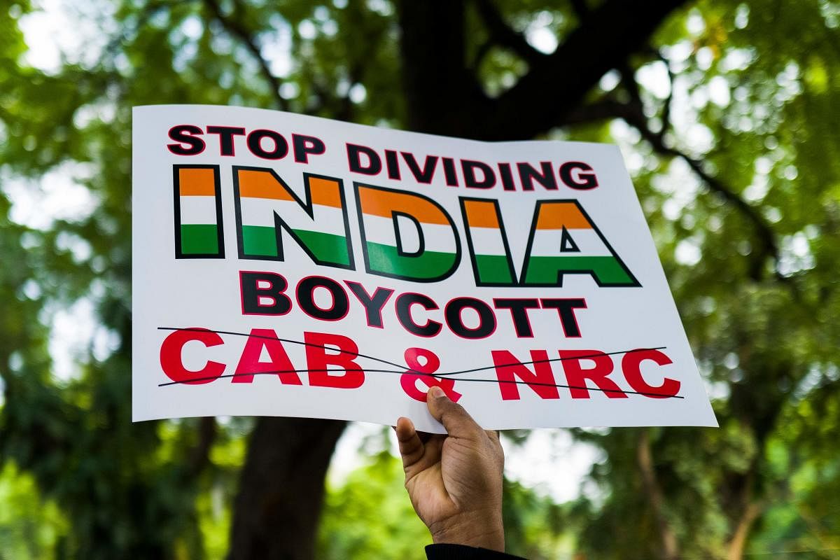 A protester displays a placard during a demonstration against the Indian government's Citizenship Amendment Bill in New Delhi. (AFP Photo)