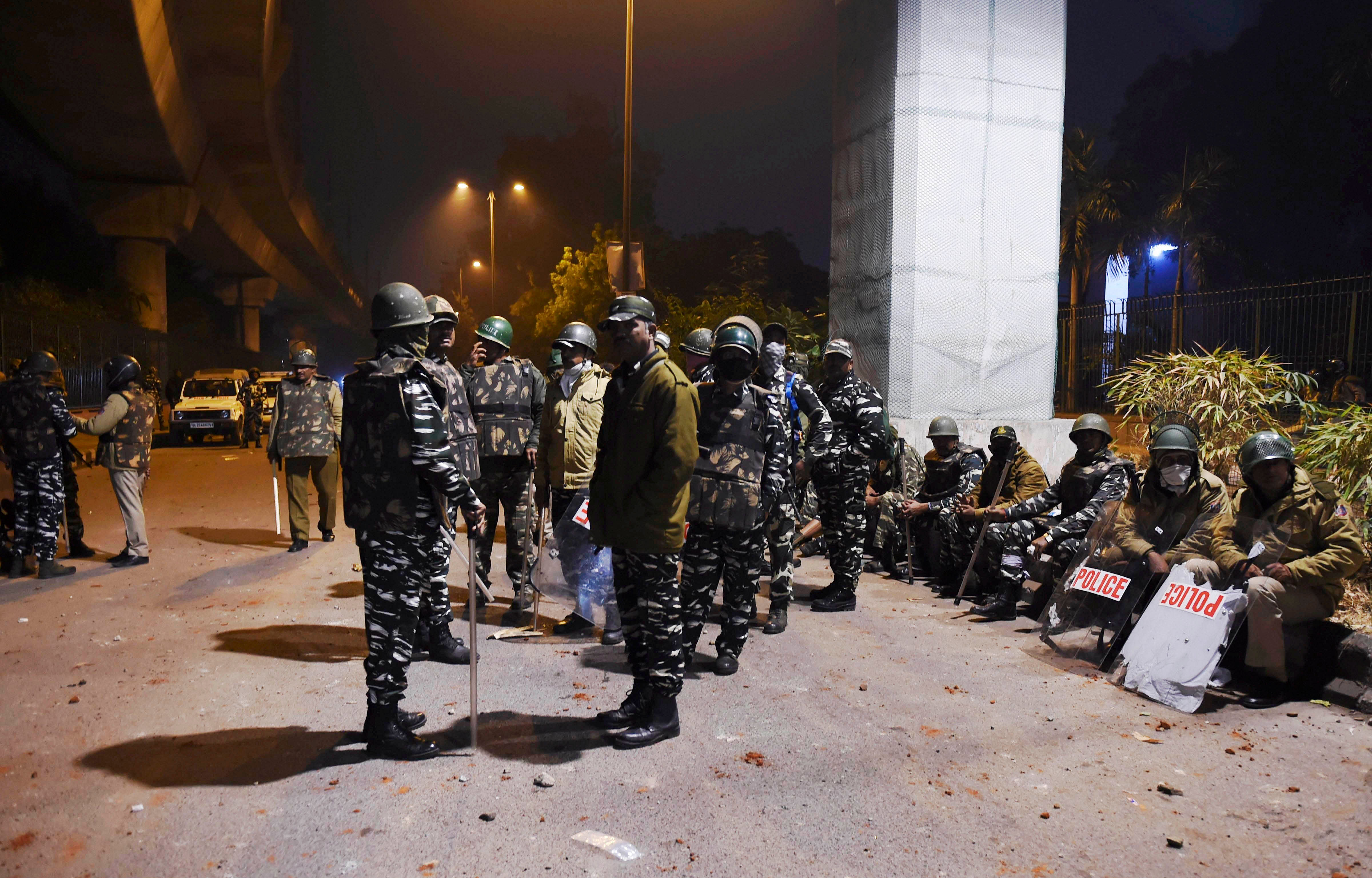 Policemen stand guard near Jamia Millia Islamia following the protests against Citizenship Amendment Act, in New Delhi. (PTI Photo)