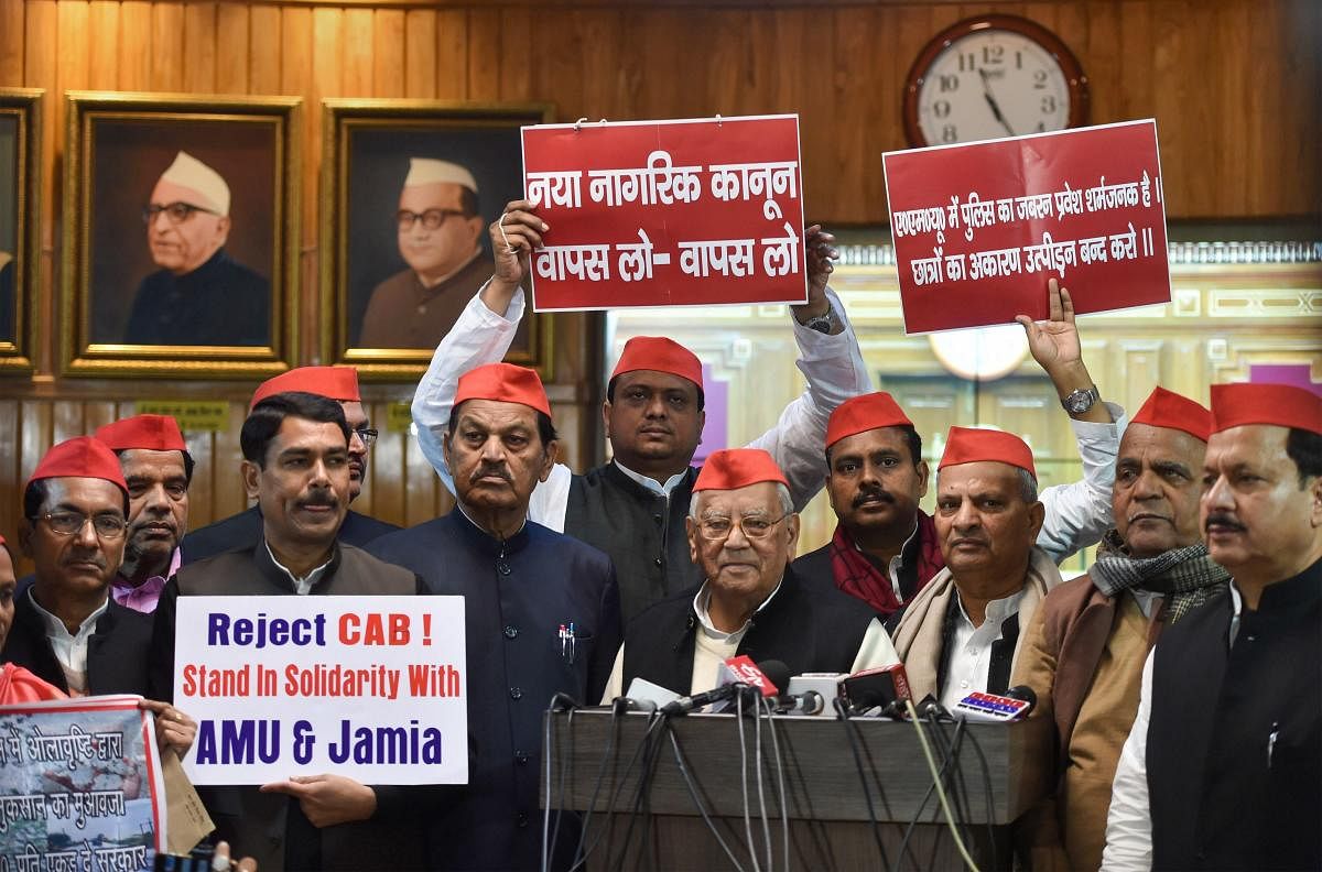 Samajwadi Party MLCs interact with mediapersons after staging a protest on student clashes over CAA, during the first day of the Winter session of the State Assembly. PTI