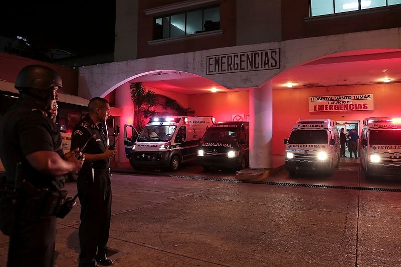 Police officers keep watch outside a hospital where injured inmates were taken following a shootout among inmates at La Joyita prison, in Panama City, Panama. (Reuters Photo)