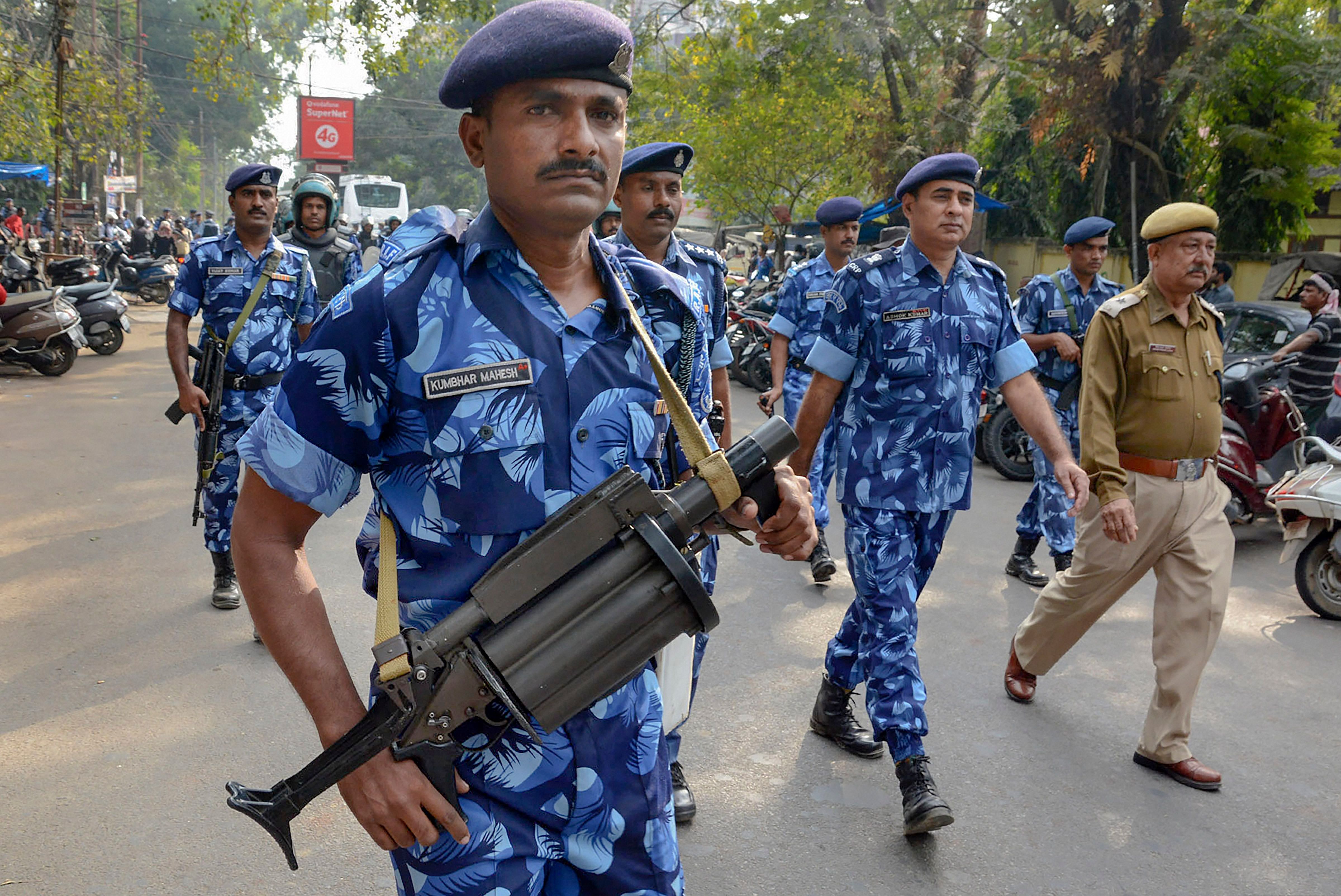 Rapid Action Force (RAF) personnel keep vigil as activists of All Assam Students Union students participate in Satyagraha rally against amendments in Citizenship Act. (PTI Photo)