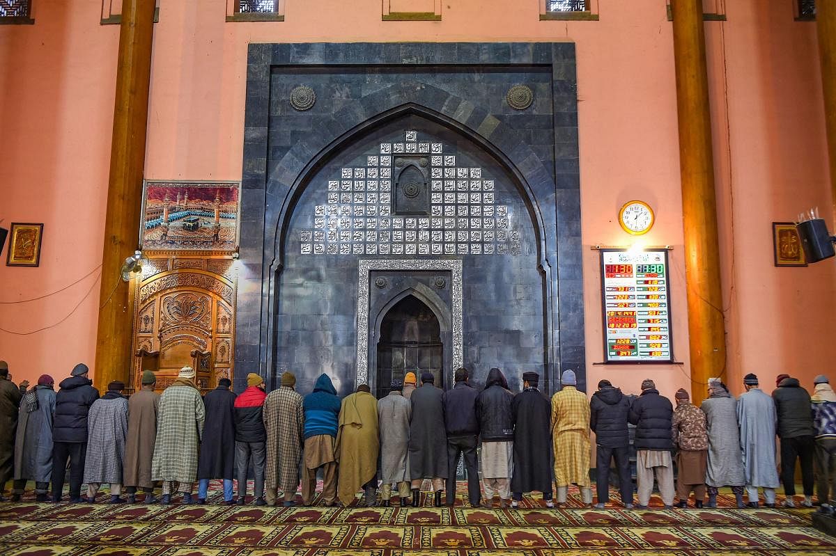 Members of Muslim community offer Zuhr prayers at the historic Jamia Masjid. (PTI Photo)
