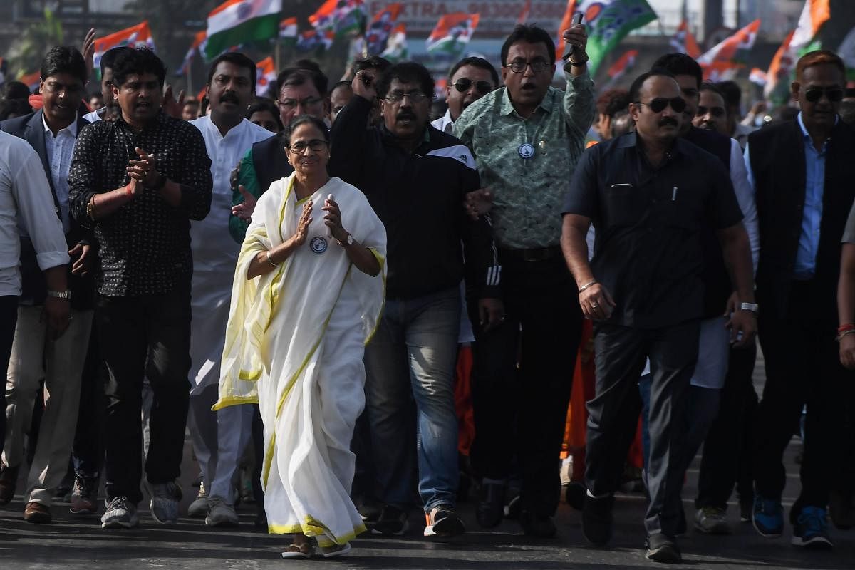 Chief minister of West Bengal state and leader of the Trinamool Congress (TMC) Mamata Banerjee alongwith party supporters walks in a mass rally crossing Howrah bridge during a protest against India's new citizenship law. (AFP Photo)