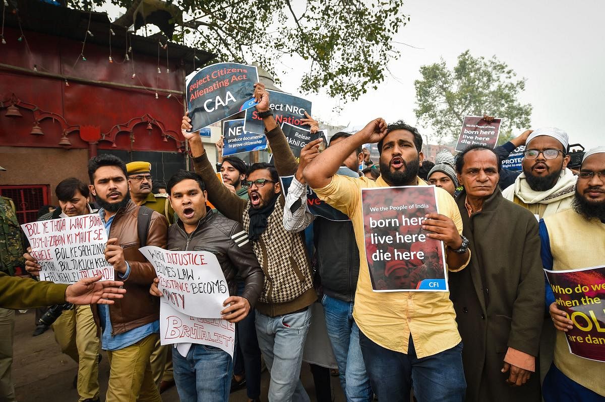  Protestors hold placards as they raise slogans during a demonstration against the Citizenship (Amendment) Act, at Red Fort in New Delhi, Thursday, Dec. 19, 2019. (PTI Photo)