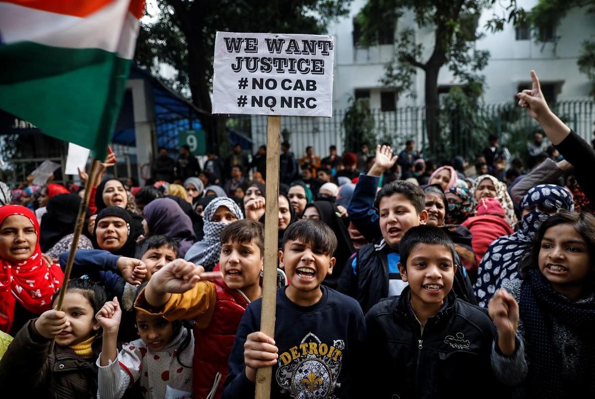 Young demonstrators shout slogans during a protest against a new citizenship law, outside the Jamia Millia Islamia university in New Delhi, India. (Reuters photo)
