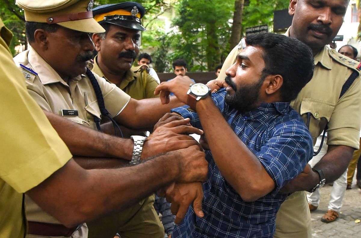 A protestor being detained by police personnel during a rally against the amended Citizenship Act, in Kochi. (PTI photo)