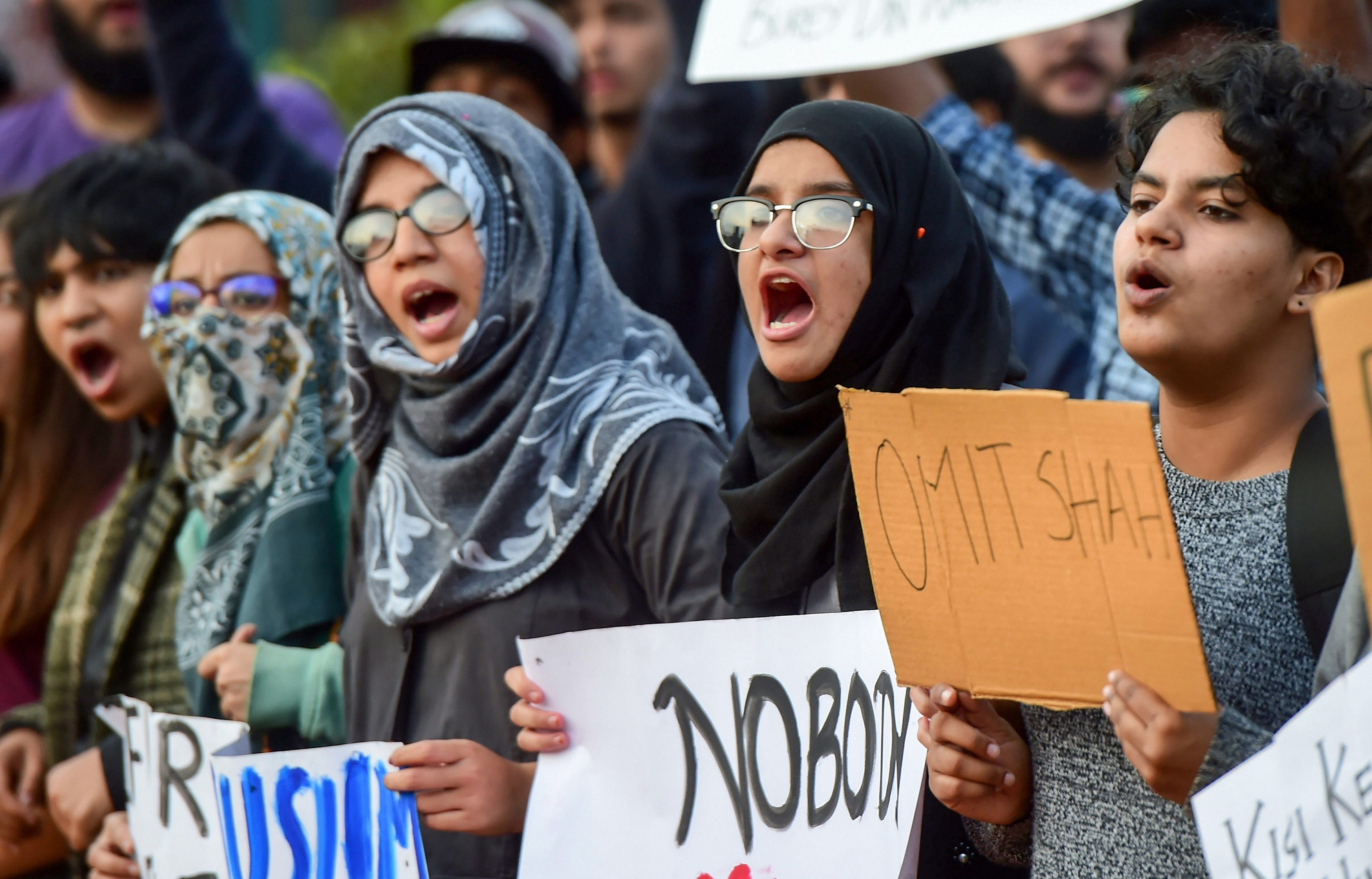 Students and protestors hold placards and raise slogans, defying prohibitory orders imposed in the area, during an anti-Citizenship Act protest rally. (PTI Photo)