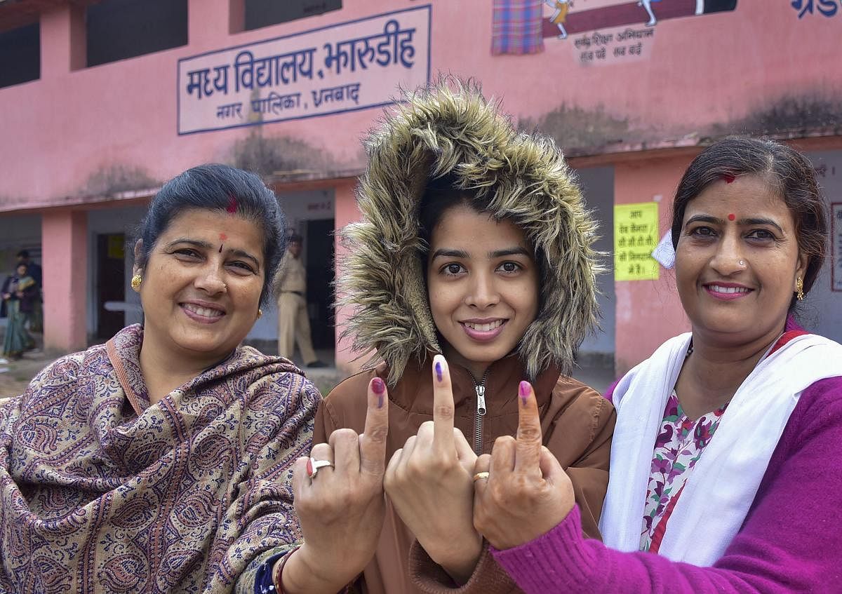 A first-time voter and her relatives show their inked finger after casting votes during the fourth phase of Jharkhand Assembly polls, in Dhanbad, Monday, Dec. 16, 2019. (PTI Photo)